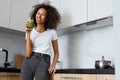 Woman drinking green detox juice, smoothie drink in kitchen