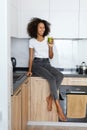 Woman drinking green detox juice, smoothie drink in kitchen Royalty Free Stock Photo