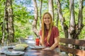 Woman drinking healthy fruits and vegetables juice smoothie in summer. Happy girl enjoying organic drink Portrait of a Royalty Free Stock Photo