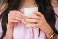 Woman drinking hot cappuccino coffee and eating cake at cafe Royalty Free Stock Photo