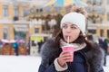 Woman drinking a hot cappuccino at a winter fair Royalty Free Stock Photo