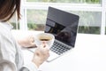 Woman drinking hot coffee while working in front of a laptop computer Royalty Free Stock Photo