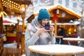 Woman drinking hot punch on German Christmas market. Royalty Free Stock Photo