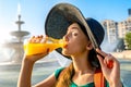 Woman drinking juice near the fountain Royalty Free Stock Photo