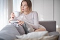 Woman drinking morning coffee in her apartment