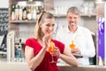 Woman drinking orange cocktail Royalty Free Stock Photo