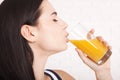 Woman drinking orange juice Beautiful mixed-race Asian, Caucasian model. Royalty Free Stock Photo