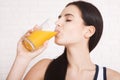 Woman drinking orange juice Beautiful mixed-race Asian, Caucasian model. Royalty Free Stock Photo