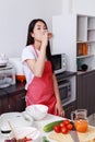 Woman drinking orange Juice in kitchen room Royalty Free Stock Photo