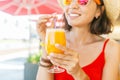 Woman drinking orange juice at restaurant bar