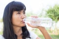 Woman Drinking Pure Water on Blur green Nature Park Background Royalty Free Stock Photo