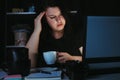 Woman drinking too much coffee at night work Royalty Free Stock Photo