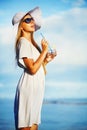 Woman drinking water on a beach