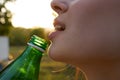 woman drinking water from a bottle face closeup enjoyment summer