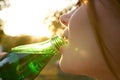 woman drinking water from a bottle face closeup enjoyment summer