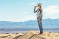 Woman drinking water in desert. Active girl quenches thirst in Death Valley, California, USA