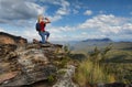 Woman drinking water on mountain summit Australia