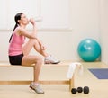 Woman drinking water and resting on bench Royalty Free Stock Photo