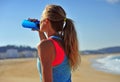 Woman drinking water after running