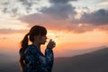 Woman drinking water on sunset background Royalty Free Stock Photo