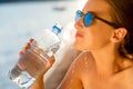 Woman drinking water from transparent bottle on Royalty Free Stock Photo