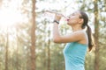 Woman drinking water after work out exercising on sunset evening Royalty Free Stock Photo