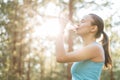 Woman drinking water after work out exercising on sunset evening Royalty Free Stock Photo