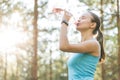 Woman drinking water after work out exercising on sunset evening Royalty Free Stock Photo
