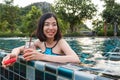 A woman drinking watermelon juice in the pool Royalty Free Stock Photo