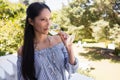 Woman drinking white wine while standing in balcony at restaurant Royalty Free Stock Photo