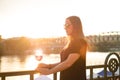 Woman drinking a wine in the city during a sunset. Glass of red wine. Concept of free time in the city and drinking alcohol. Royalty Free Stock Photo