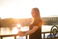 Woman drinking a wine in the city during a sunset. Glass of red wine. Concept of free time in the city and drinking alcohol.