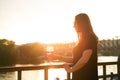 Woman drinking a wine in the city during a sunset. Glass of red wine. Concept of free time in the city and drinking alcohol. Royalty Free Stock Photo