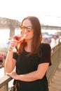 Woman drinking a wine in the city during a sunset. Glass of red wine. Concept of free time in the city and drinking alcohol. Royalty Free Stock Photo