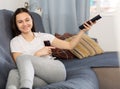 Woman drinking wine watching TV at home Royalty Free Stock Photo