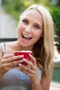 Woman drinks coffe outdoor on a hot summer afternooon