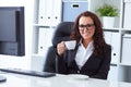 Woman drinks coffee in office Royalty Free Stock Photo