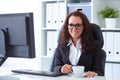 Woman drinks coffee in office Royalty Free Stock Photo