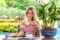 Woman drinks coffee or tea cup with desserts in outdoor restaurant