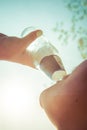 Woman drinks a fizzy drink in sun rays refreshing in hot day Royalty Free Stock Photo