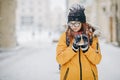 Woman Drinks Hot Tea or Coffee From a Cozy Cup on Snowy Winter Morning Outdoors Royalty Free Stock Photo