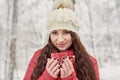 Woman Drinks Hot Tea or Coffee From Cup at Cozy Snowy House Garden on Winter Morning. Beautiful Girl Enjoying Winter Outdoors with Royalty Free Stock Photo