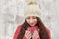 Woman Drinks Hot Tea or Coffee From Cup at Cozy Snowy House Garden on Winter Morning. Beautiful Girl Enjoying Winter Outdoors with Royalty Free Stock Photo