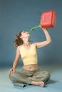 Woman drinks of jerry can