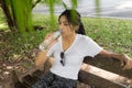 Woman drinks water from bottle in the park Royalty Free Stock Photo