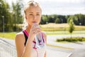 Woman drinks water after running at the countryside Royalty Free Stock Photo