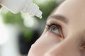 Woman drips eye drops into eye for allergies closeup Royalty Free Stock Photo