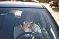 Woman driver being hot during heat wave in car, suffering from hot weather wipes sweat from neck