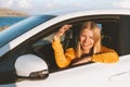 Woman driver in a car showing keys. Rental auto road trip vacations Royalty Free Stock Photo