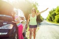 Woman driver with a child on a country road, near a broken car. Royalty Free Stock Photo